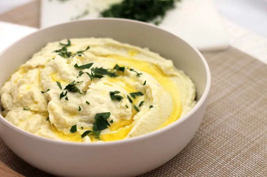 A delicious, creamy and buttery Keto Cauliflower Mash recipe will be your go to Keto side dish for years to come! Using the microwave and a blender, this keto mash recipe is ready in 10 minutes flat. #ketosidedish #ketocauliflower #ketorecipe #keto