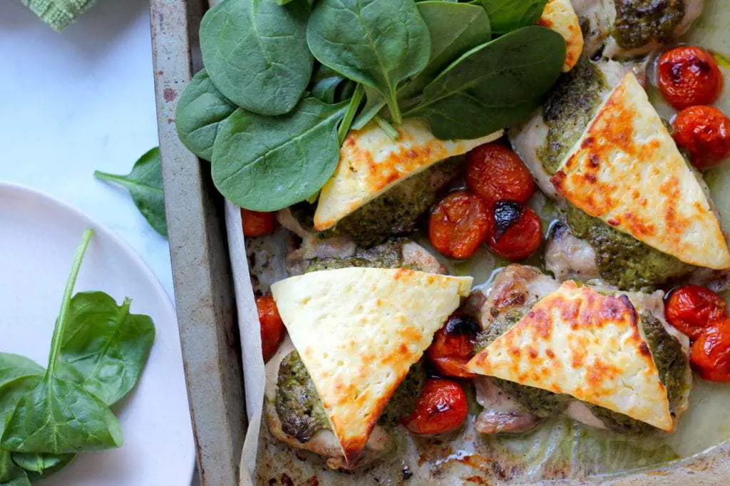 Keto Pesto Chicken Bake with Haloumi recipe by Aussie Keto Queen. Succulent chicken thighs, topped with basil pesto and haloumi and grilled to perfect. A quick family favourite that is no fuss! Serves two small chicken thighs per person.