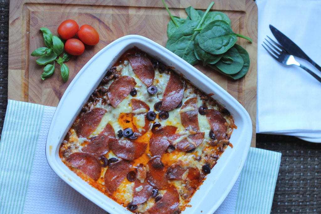Keto Pizza Casserole with Cauliflower by Aussie Keto Queen.  This Keto Pizza Casserole could turn some cauli-haters into cauli-lovers in one mouthful. Using a base of cauliflower makes this dish a tasty alternative to the carb laden normal pizza, and with none of the fuss of making your own keto base. It is very calorie dense and rich, so serve it with a fresh green salad. All the flavour, none of the carbs! #keto #ketorecipes #ketogenicdiet