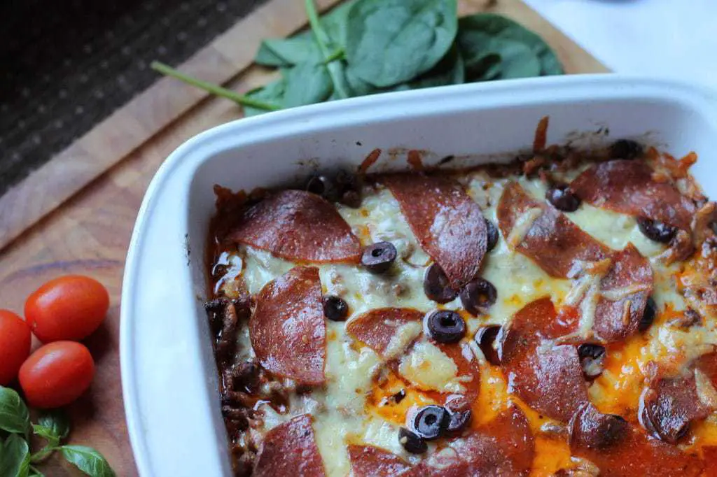 Keto Pizza Casserole with Cauliflower by Aussie Keto Queen.  This Keto Pizza Casserole could turn some cauli-haters into cauli-lovers in one mouthful. Using a base of cauliflower makes this dish a tasty alternative to the carb laden normal pizza, and with none of the fuss of making your own keto base. It is very calorie dense and rich, so serve it with a fresh green salad. All the flavour, none of the carbs!  #keto #ketorecipes #ketogenicdiet