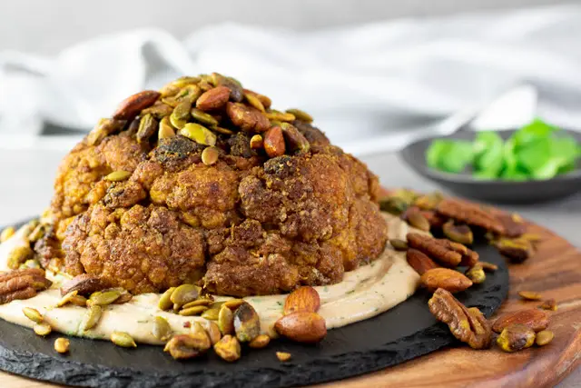 Vegetarian Keto Whole Roasted Cauliflower is bursting with Middle Eastern spices and so much flavour, plus a crunchy nutmix on top and a tasty tahini dressing. The ultimate vegetarian Keto main, or a fantastic side dish!