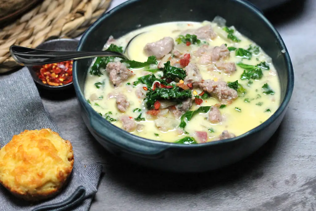 Keto Zuppa Toscana Soup by Aussie Keto Queen. Keto Zuppa Toscana Soup is not your typical soup! It is creamy, hearty, filling and a little spicy. Using Italian sausage brings an amazing depth of flavour and combined with bacon, the broth is so packed with flavour it will knock your socks off. The perfect winter Keto Soup! 